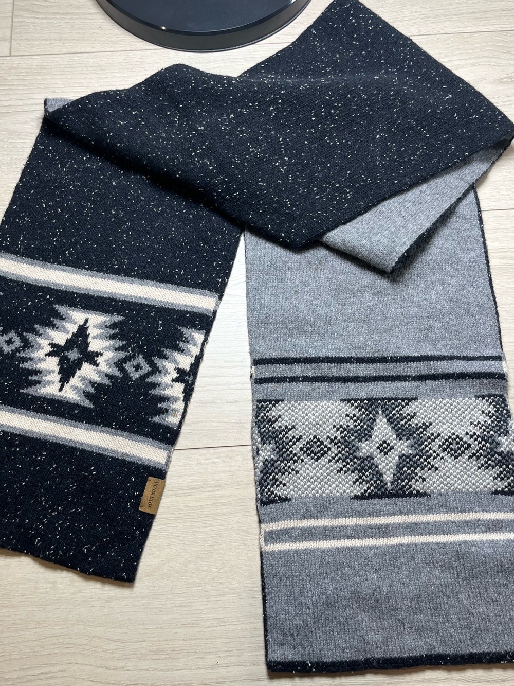 The Pendleton Men's Wool Knit Scarf in Black, Gray, and White features a stylis
